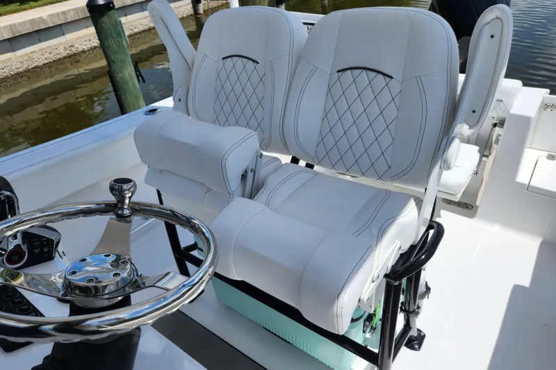 Slide: The Image of 2024 Sportsman Open 232 Center Console with luxurious white seating and sleek steering wheel. - 13