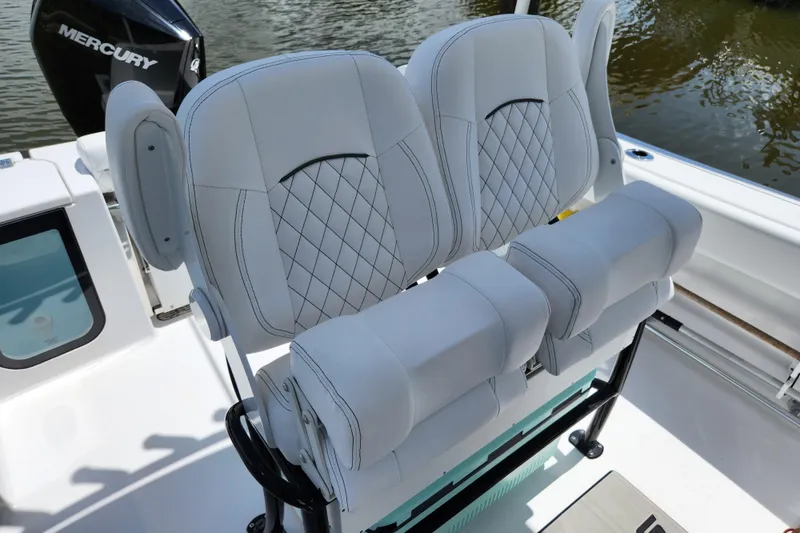 Slide: The Image of 2024 Sportsman Open 232 Center Console boat with luxurious seating and Mercury engine. - 14