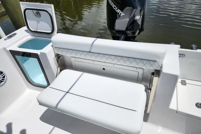 Slide: The Image of 2024 Sportsman Open 232 Center Console boat interior with seating and storage. - 15