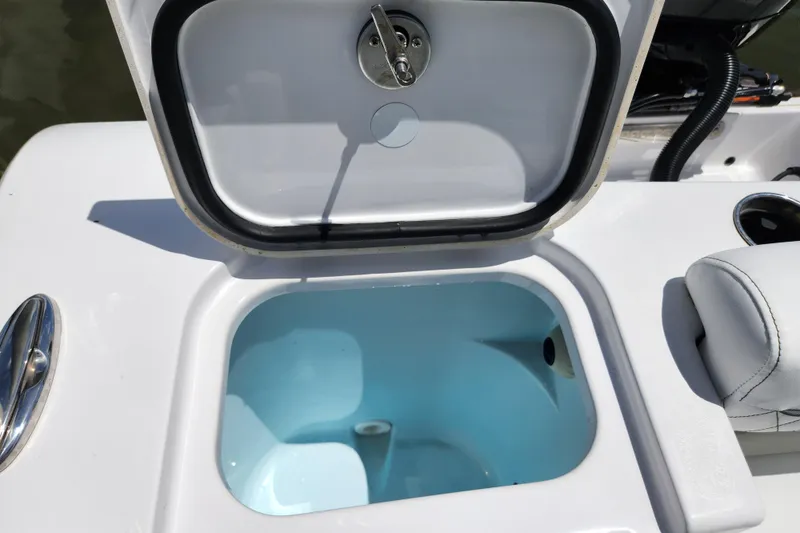 Slide: The Image of 2024 Sportsman Open 232 Center Console livewell with open lid, showcasing interior. - 17