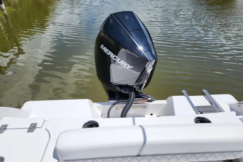 Slide: The Image of 2024 Sportsman Open 232 Center Console with Mercury outboard engine on water. - 19