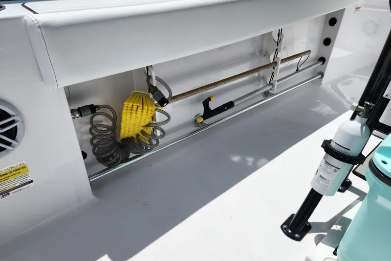 Slide: The Image of 2024 Sportsman Open 232 Center Console boat interior with cleaning tools and equipment storage. - 21