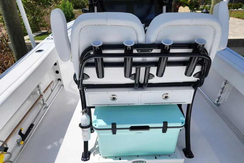 Slide: The Image of 2024 Sportsman Open 232 Center Console boat interior with rod holders and storage. - 23