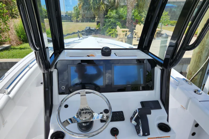 Slide: The Image of 2024 Sportsman Open 232 Center Console dashboard with dual screens and steering wheel. - 25