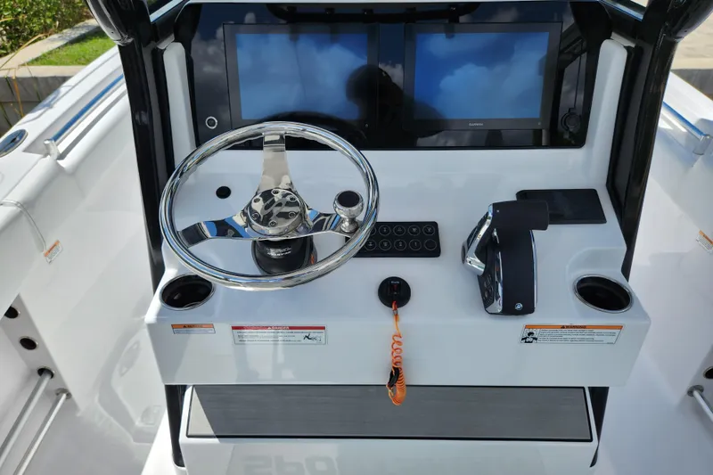 Slide: The Image of 2024 Sportsman Open 232 Center Console dashboard with dual screens and steering wheel. - 26