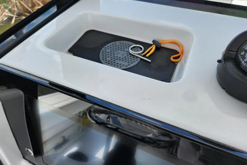 Slide: The Image of 2024 Sportsman Open 232 Center Console dashboard with compass and key holder. - 29