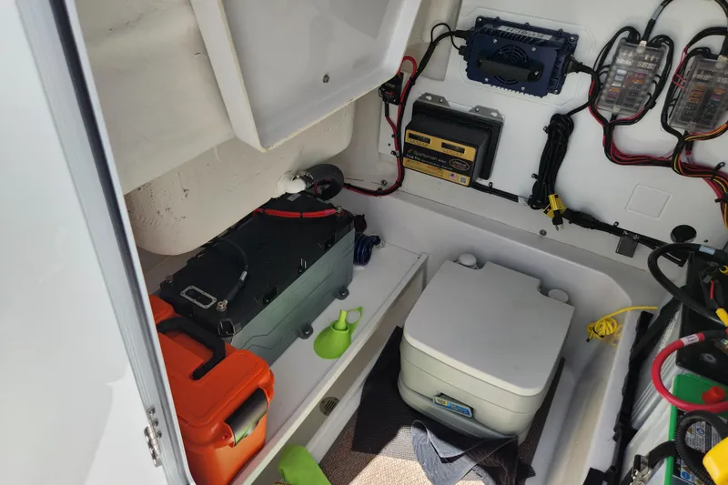 Slide: The Image of 2024 Sportsman Open 232 Center Console interior with equipment and wiring setup. - 37