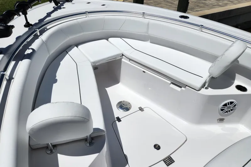 Slide: The Image of 2024 Sportsman Open 232 Center Console boat interior with white cushioned seating. - 4