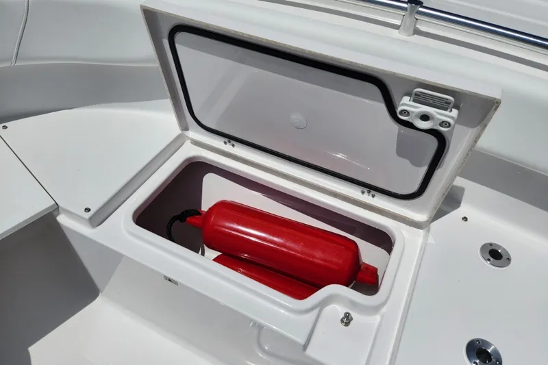 Slide: The Image of 2024 Sportsman Open 232 Center Console storage compartment with red buoy inside. - 45