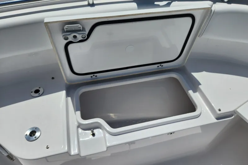 Slide: The Image of Open storage compartment on 2024 Sportsman Open 232 Center Console boat. - 46