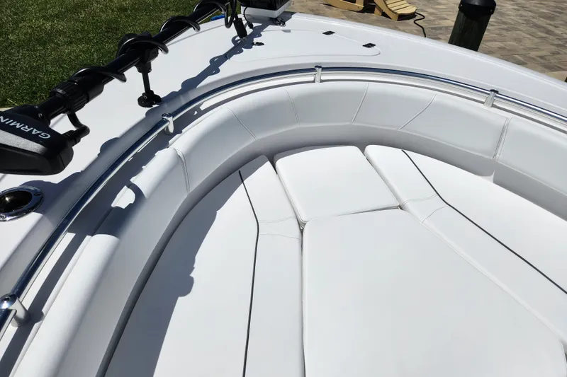 Slide: The Image of 2024 Sportsman Open 232 Center Console boat with white cushioned seating. - 7