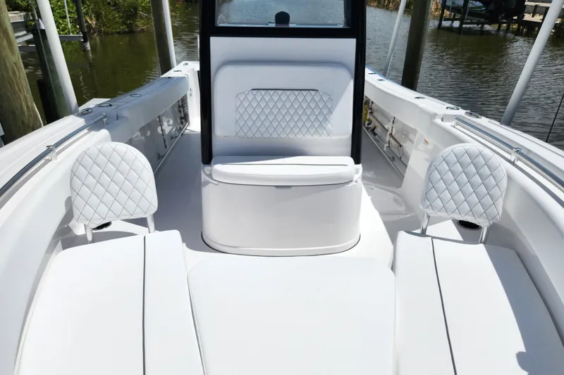 Slide: The Image of 2024 Sportsman Open 232 Center Console boat interior with white quilted seating. - 9