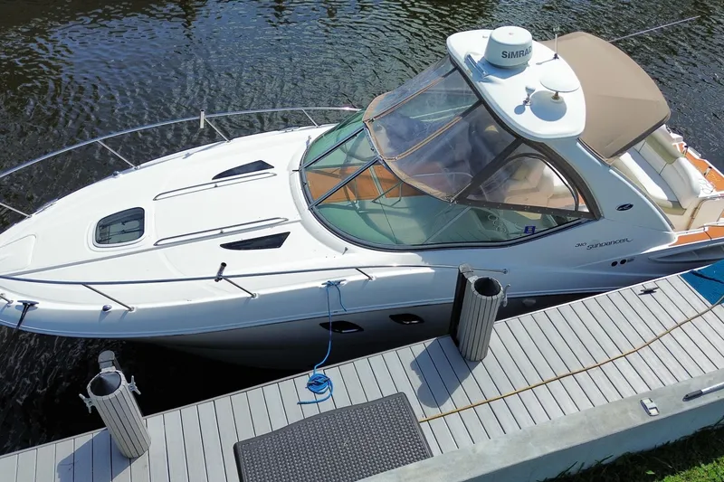 Slide: The Image of 2007 Sea Ray Sundancer 310 docked, showcasing sleek design and spacious deck. - 1