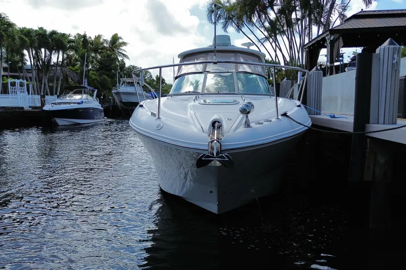 Slide: The Image of 2007 Sea Ray Sundancer 310 docked in a scenic marina with palm trees. - 15