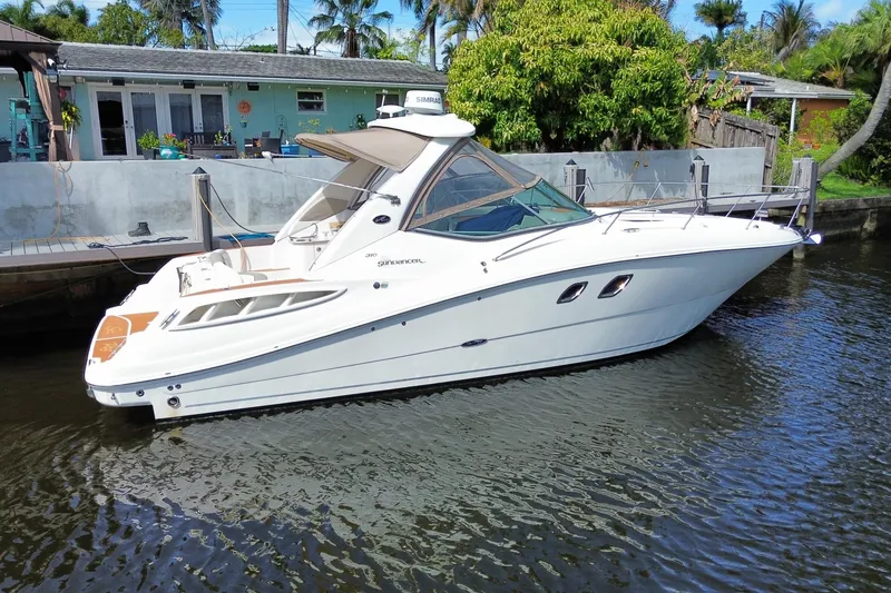 Slide: The Image of 2007 Sea Ray Sundancer 310 yacht docked by a waterfront home. - 17