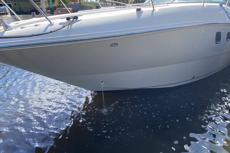 Slide: The Image of 2007 Sea Ray Sundancer 310 boat on water, side view with visible hull details. - 18