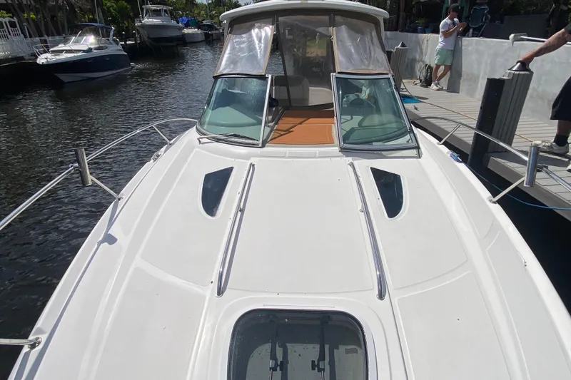 Slide: The Image of 2007 Sea Ray Sundancer 310 docked, showcasing sleek design and spacious deck. - 19