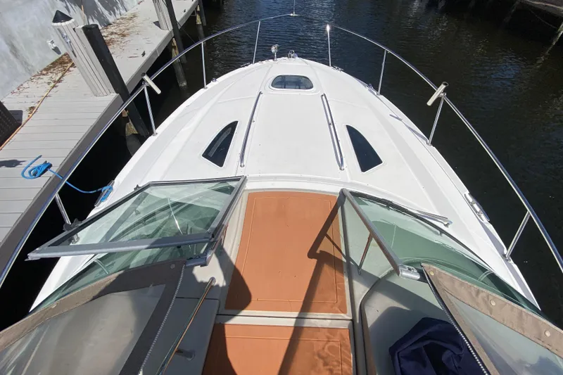 Slide: The Image of 2007 Sea Ray Sundancer 310 yacht deck view, docked by the water. - 20