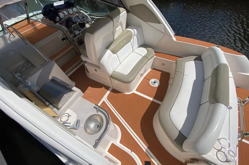 Slide: The Image of 2007 Sea Ray Sundancer 310 boat interior with seating, helm, and sink. - 25