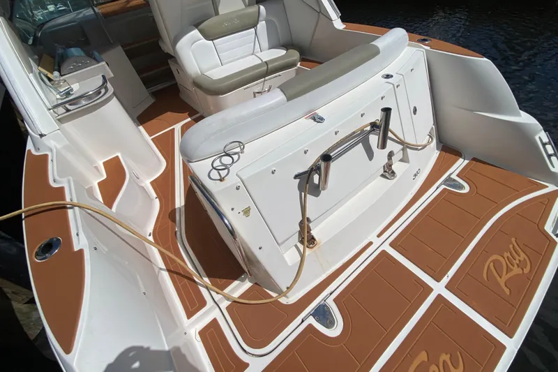 Slide: The Image of 2007 Sea Ray Sundancer 310 boat interior with cushioned seating and teak-style flooring. - 27