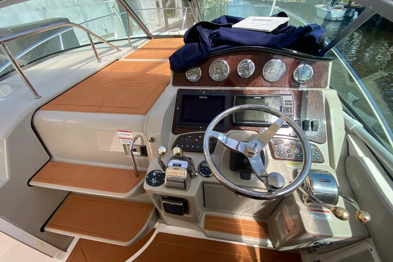 Slide: The Image of 2007 Sea Ray Sundancer 310 helm with steering wheel, gauges, and navigation equipment. - 32