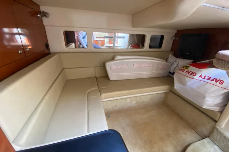Slide: The Image of 2007 Sea Ray Sundancer 310 cabin interior with beige seating and safety gear. - 39