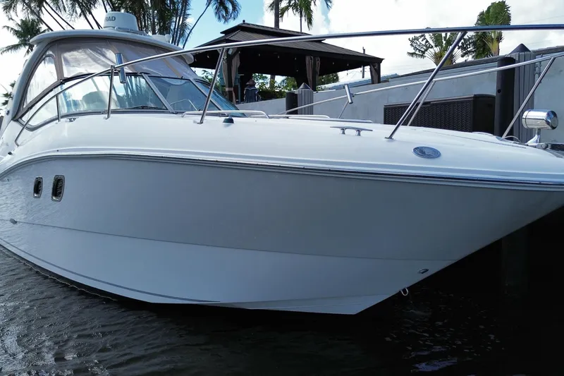 Slide: The Image of 2007 Sea Ray Sundancer 310 yacht docked near palm trees. - 4