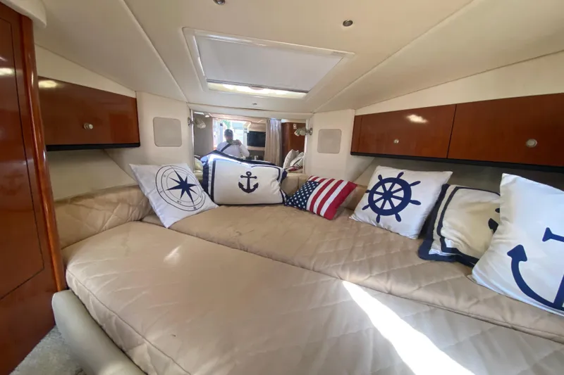 Slide: The Image of Interior of 2007 Sea Ray Sundancer 310 with nautical-themed pillows and cozy seating. - 40