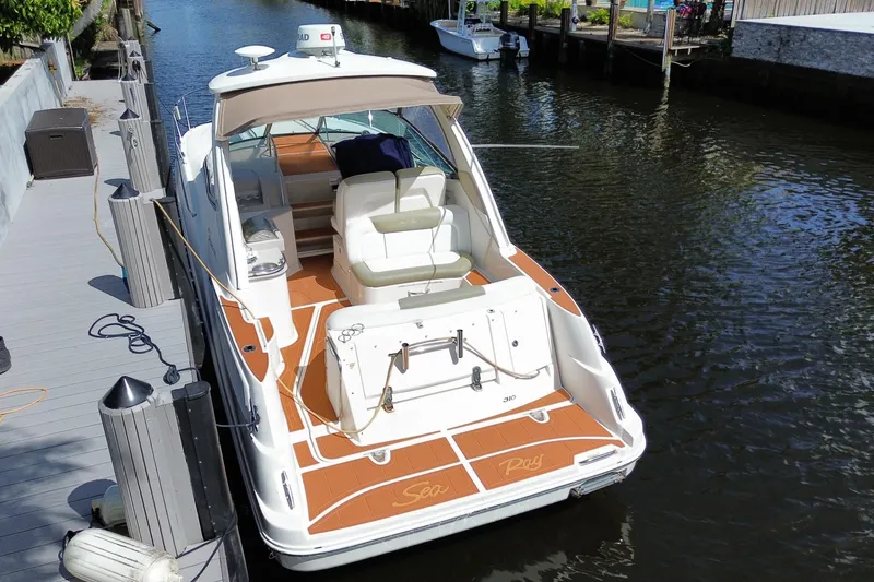 Slide: The Image of 2007 Sea Ray Sundancer 310 docked in a serene canal setting. - 42
