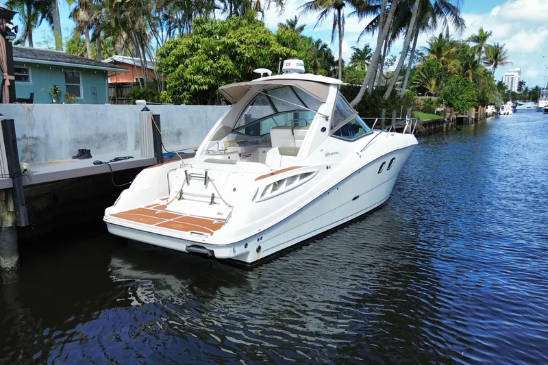 Slide: The Image of 2007 Sea Ray Sundancer 310 yacht docked in a scenic canal setting. - 44