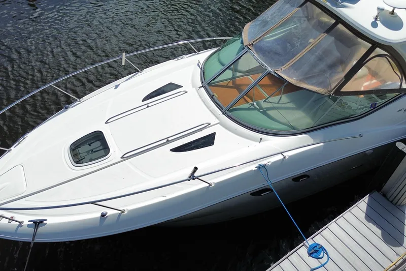 Slide: The Image of 2007 Sea Ray Sundancer 310 docked, showcasing sleek design and spacious deck. - 5