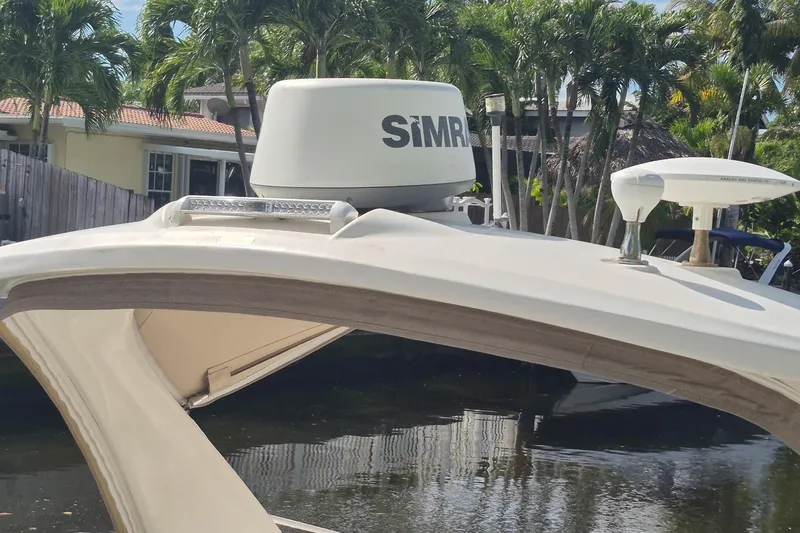 Slide: The Image of 2007 Sea Ray Sundancer 310 with radar equipment, docked near tropical trees. - 51