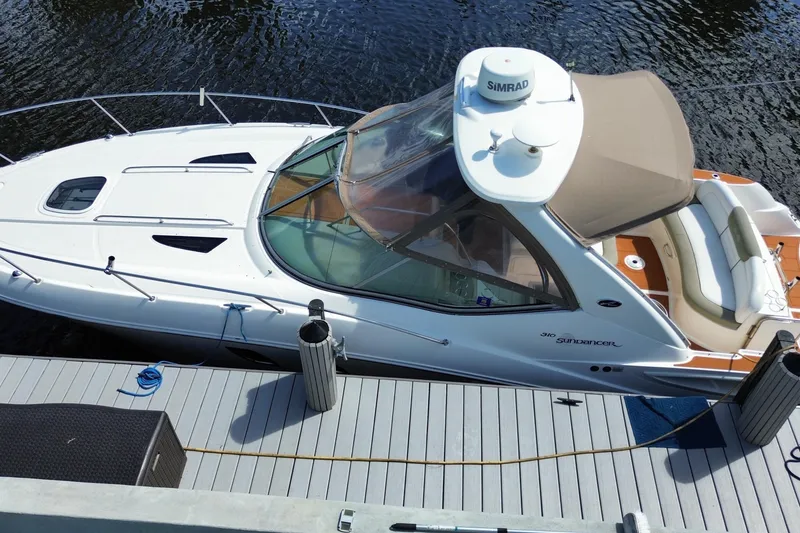 Slide: The Image of 2007 Sea Ray Sundancer 310 docked, featuring sleek design and spacious seating. - 7