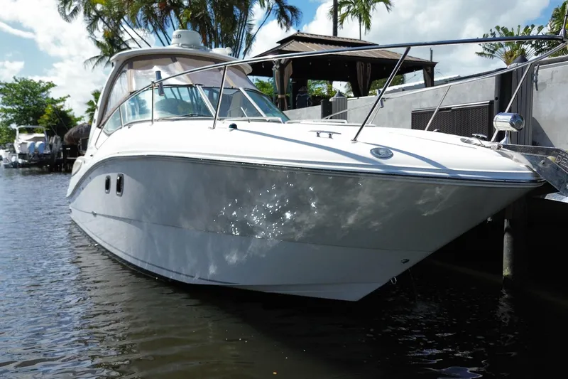 Slide: The Image of 2007 Sea Ray Sundancer 310 yacht docked in a sunny marina setting. - 8