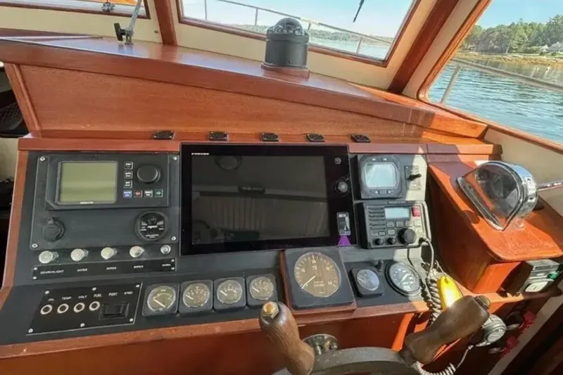 Slide: The Image of Control panel of a 2003 Snug Harbor Shearwater boat with navigation instruments. - 12