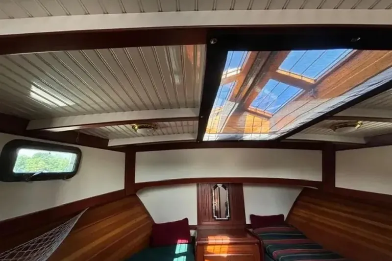 Slide: The Image of Interior of 2003 Snug Harbor Shearwater boat with wooden accents and skylight. - 16