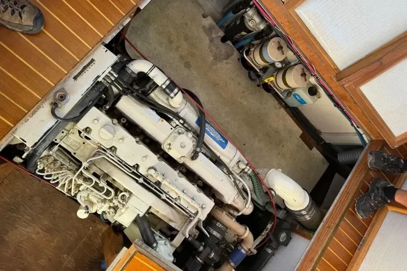 Slide: The Image of Engine compartment of a 2003 Snug Harbor Shearwater boat, showcasing detailed machinery. - 2