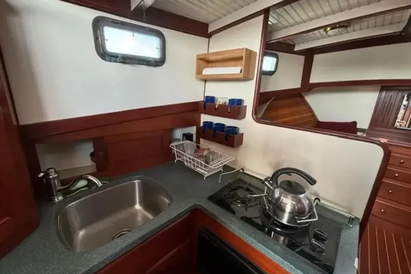 Slide: The Image of Galley kitchen in 2003 Snug Harbor Shearwater boat with sink and stove. - 20