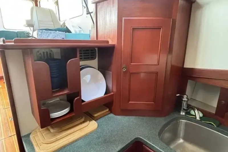Slide: The Image of Interior of 2003 Snug Harbor Shearwater boat with wooden cabinetry and kitchen sink. - 22