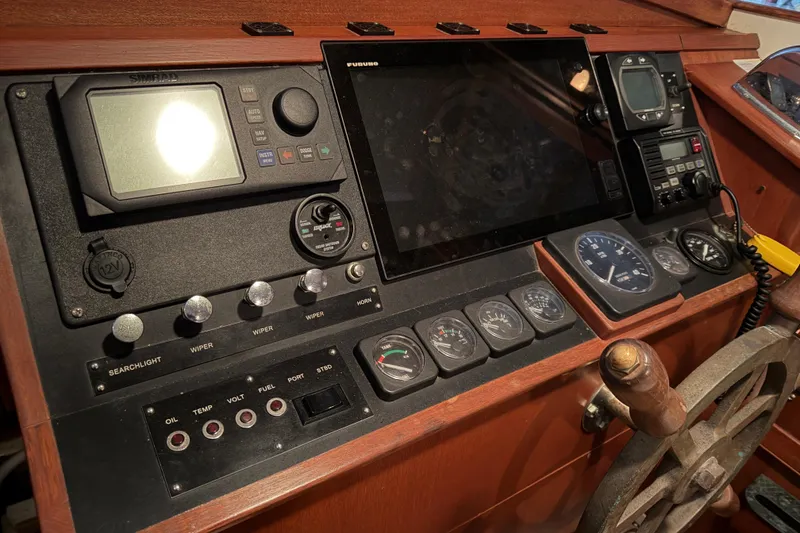 Slide: The Image of Control panel of a 2003 Snug Harbor Shearwater boat with navigation instruments. - 27