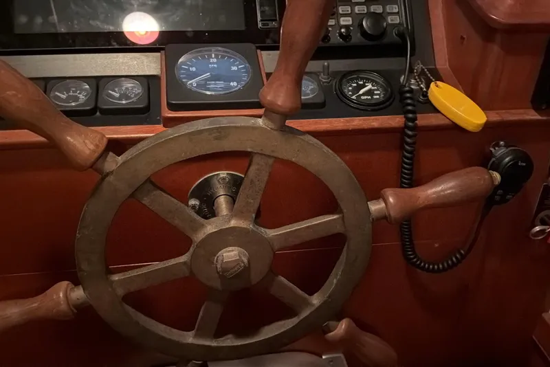 Slide: The Image of Wooden ship wheel and dashboard of 2003 Snug Harbor Shearwater boat. - 28