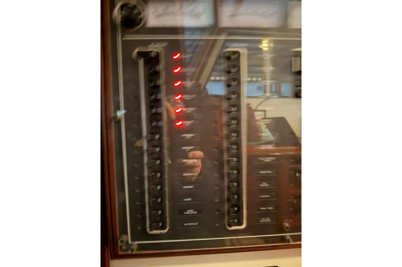 Slide: The Image of Electrical panel of a 2003 Snug Harbor Shearwater boat with illuminated switches. - 29