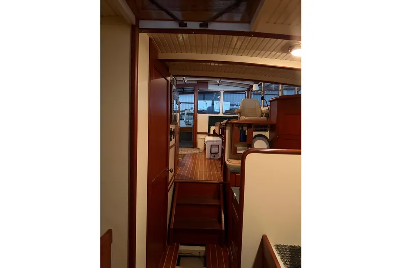 Slide: The Image of Interior of 2003 Snug Harbor Shearwater boat with wooden finishes and seating area. - 37