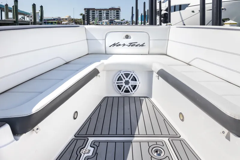 Slide: The Image of 2018 Nor-Tech 390 Sport Center Console boat interior with white seating and speaker. - 12