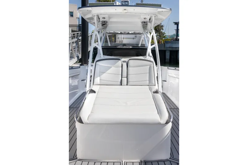 Slide: The Image of 2018 Nor-Tech 390 Sport Center Console boat with sleek white seating and modern design. - 14