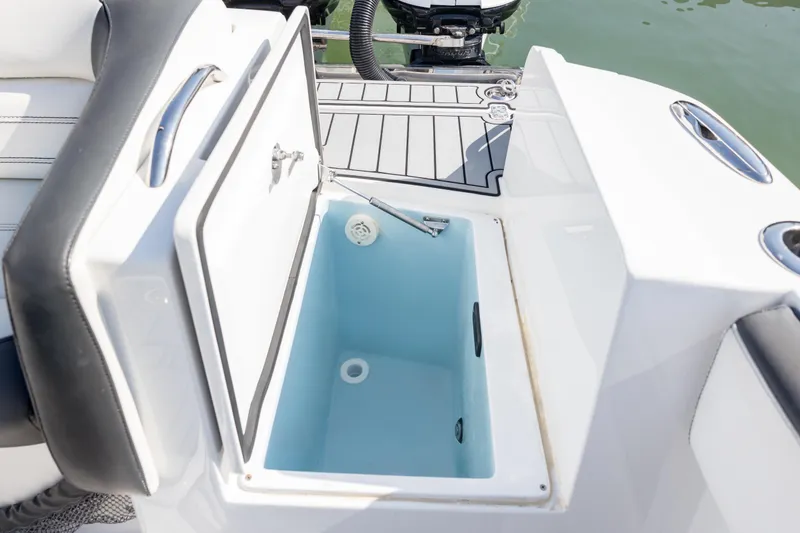 Slide: The Image of Open storage compartment on 2018 Nor-Tech 390 Sport Center Console boat. - 15