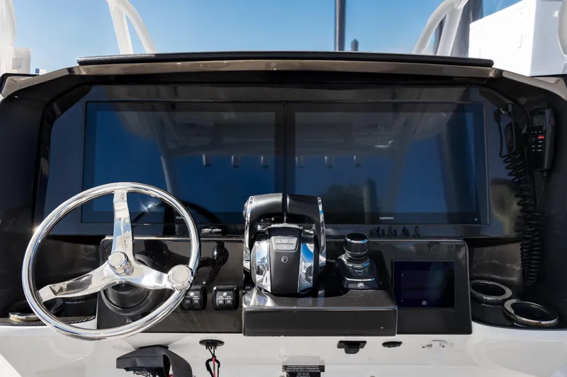 Slide: The Image of 2018 Nor-Tech 390 Sport Center Console dashboard with steering wheel and navigation screens. - 17