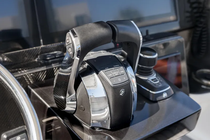 Slide: The Image of Throttle controls on a 2018 Nor-Tech 390 Sport Center Console boat dashboard. - 18