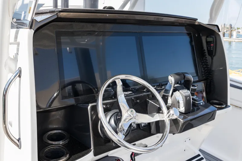 Slide: The Image of 2018 Nor-Tech 390 Sport Center Console helm with dual screens and steering wheel. - 20