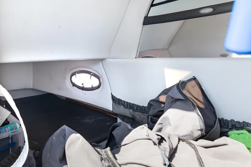 Slide: The Image of Interior cabin of 2018 Nor-Tech 390 Sport Center Console boat with storage and porthole. - 23